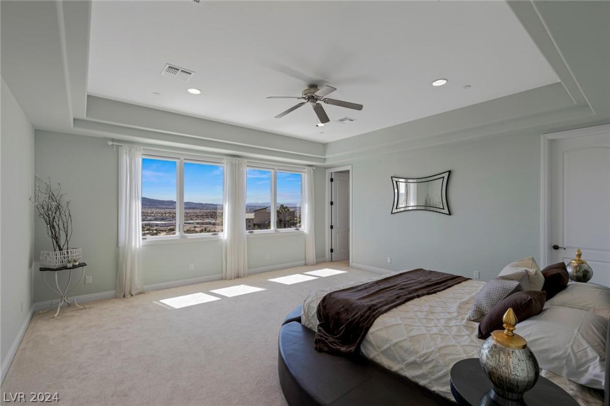 Bedroom with carpet flooring and glass windows.