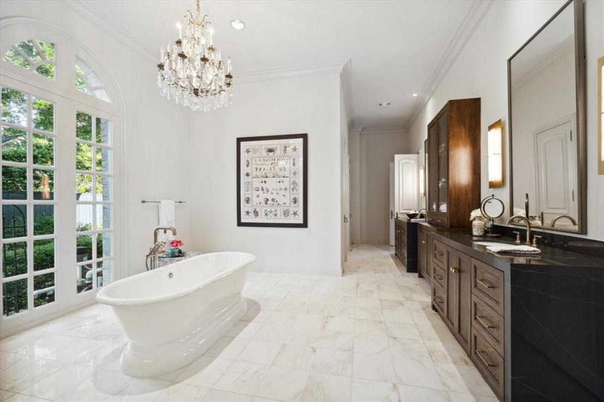 Bathroom with a chandelier and a soaking tub.