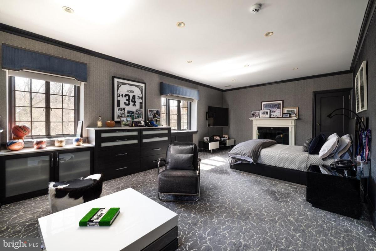 Bedroom with a fireplace and a living space.