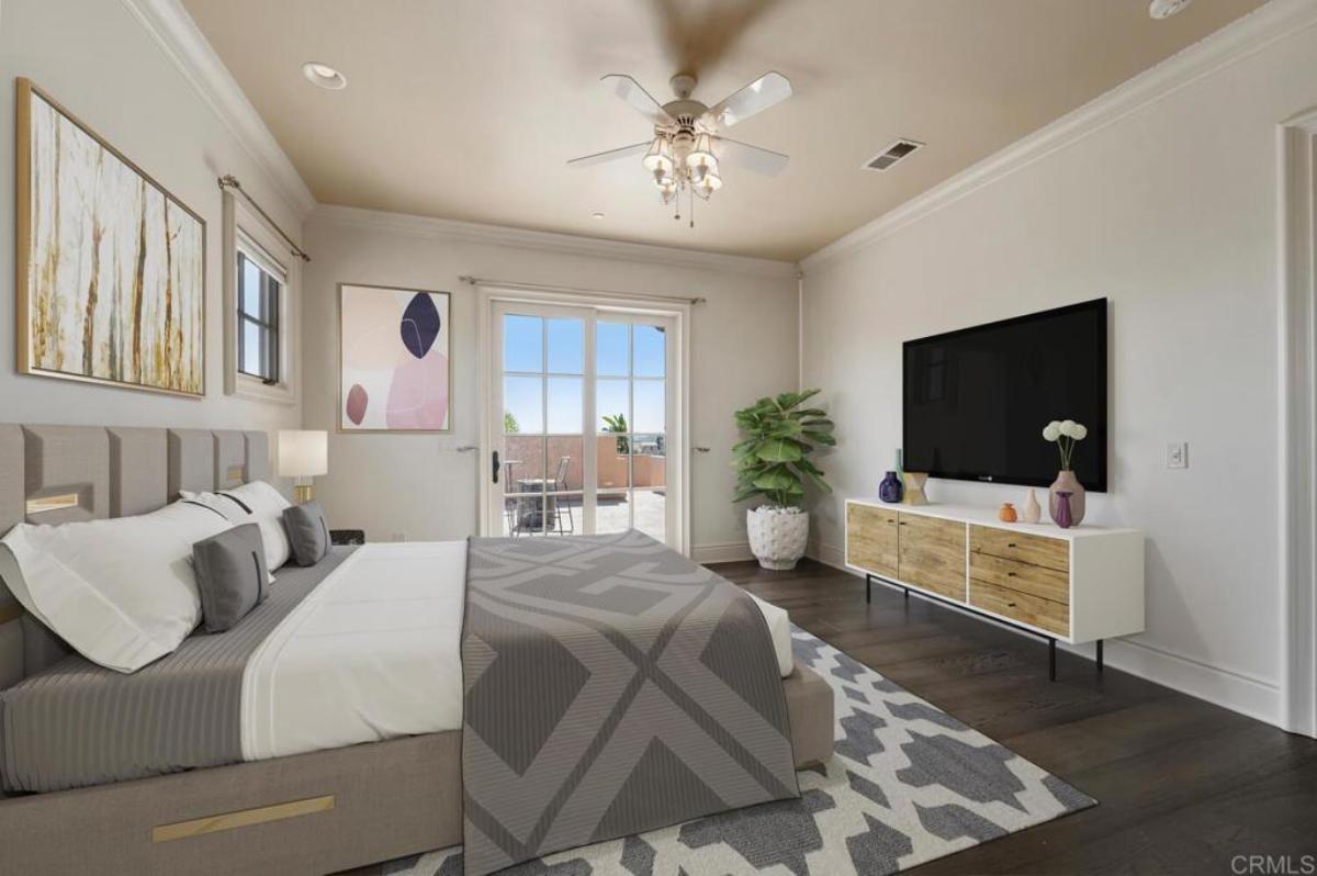 Bedroom with hardwood floors, TV and glass doors.