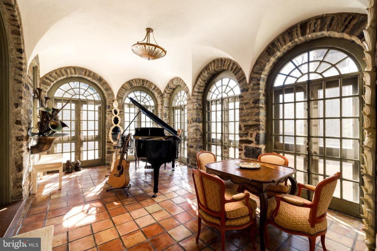 Music room with a piano, guitar, a table and chairs.