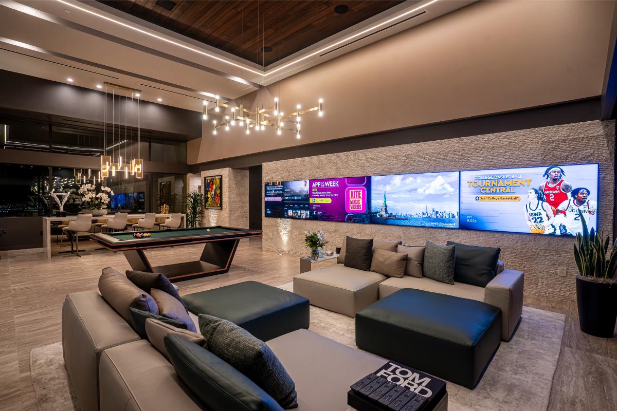 Recreational room with couches, billiards table and TVs.