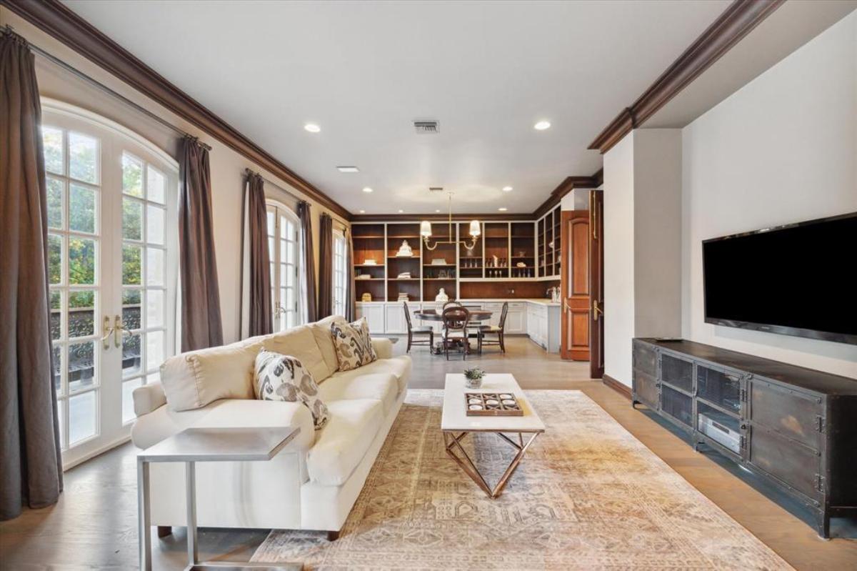 Family room with a sofa, tables and chairs.