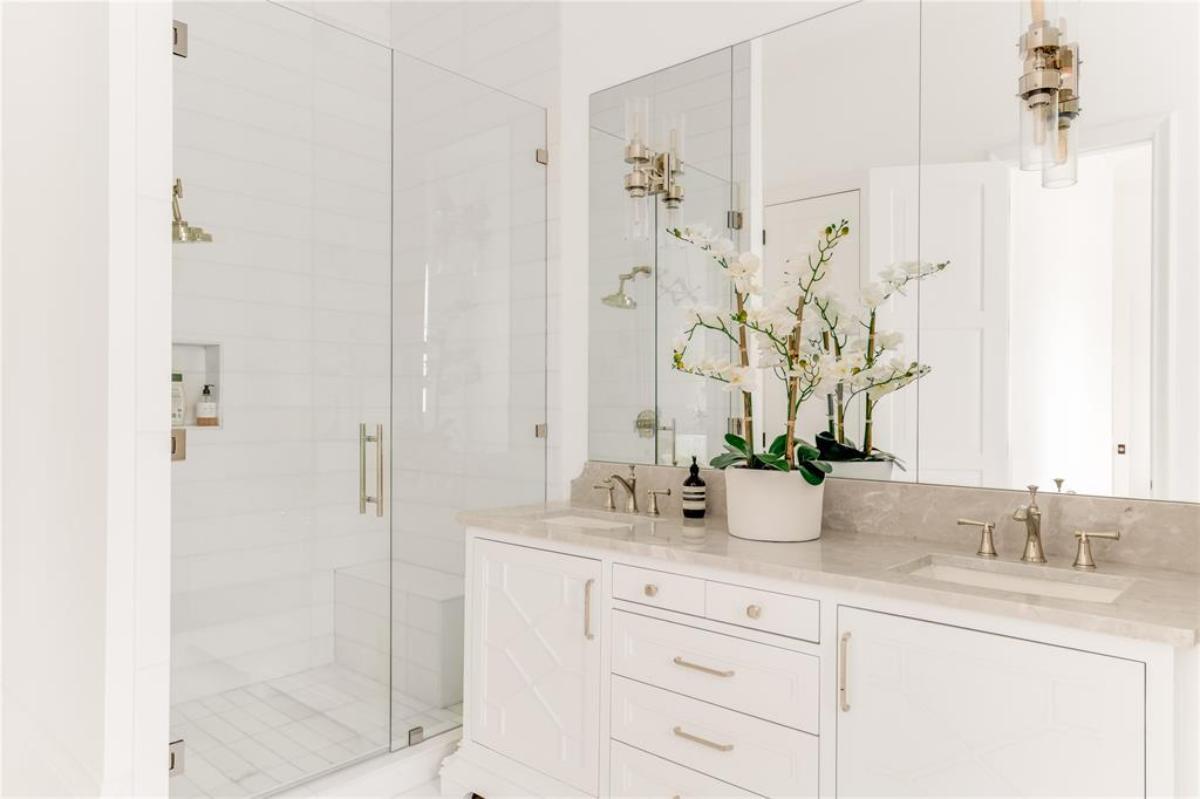 Bathroom with sinks and a walk-in shower.
