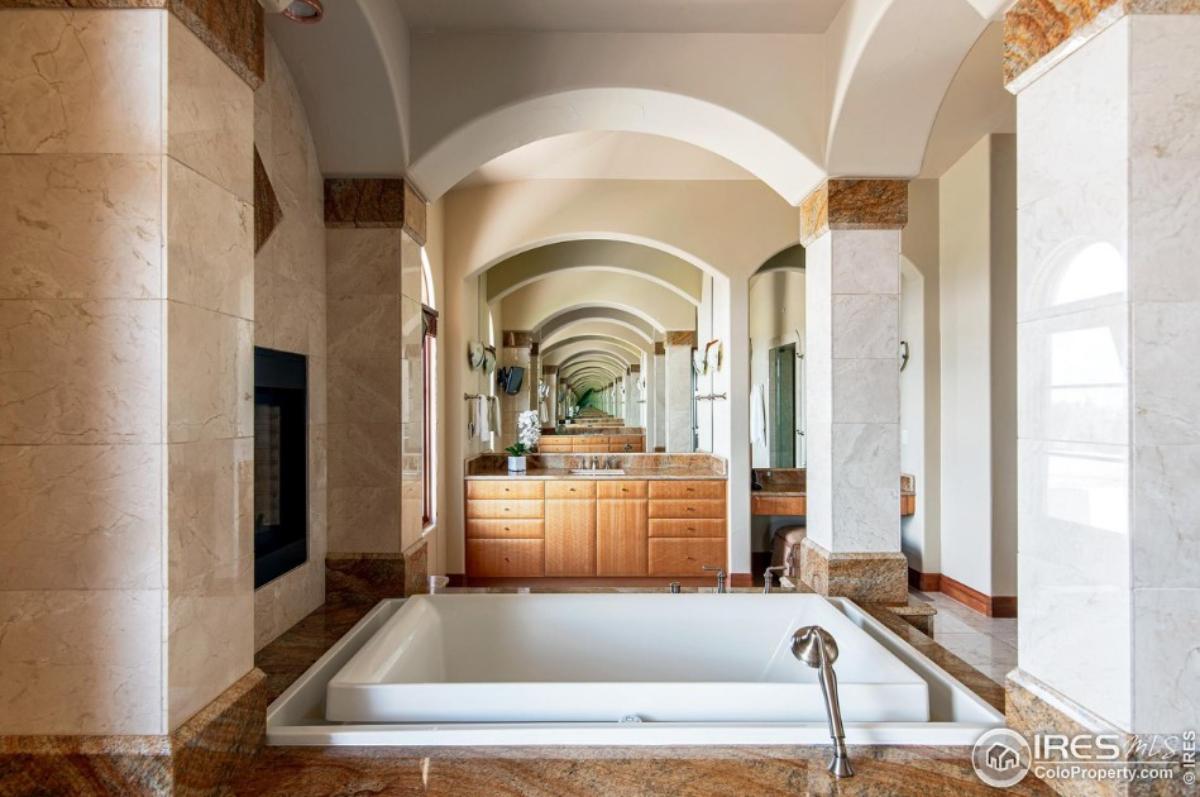 Bathroom with a sink and a soaking tub.
