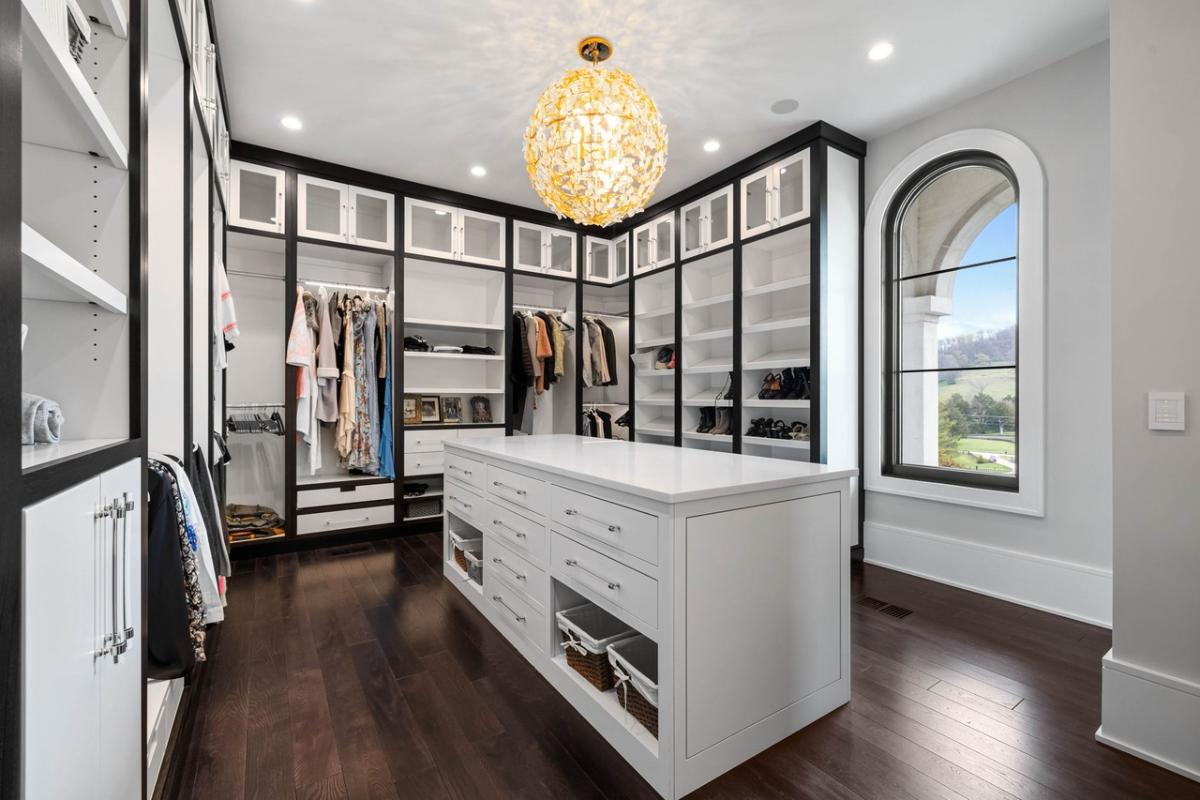 Walk-in closet with a chandelier.