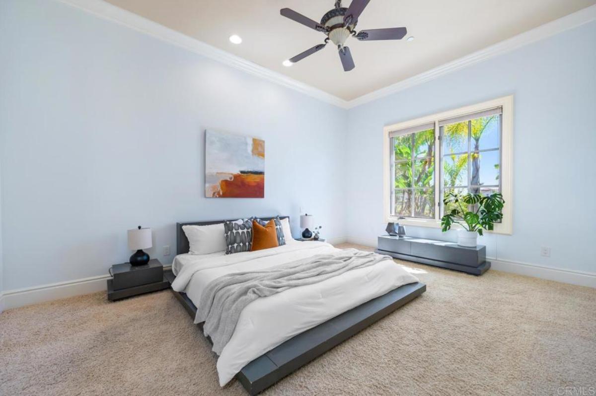 Bedroom with carpet flooring and glass windows.
