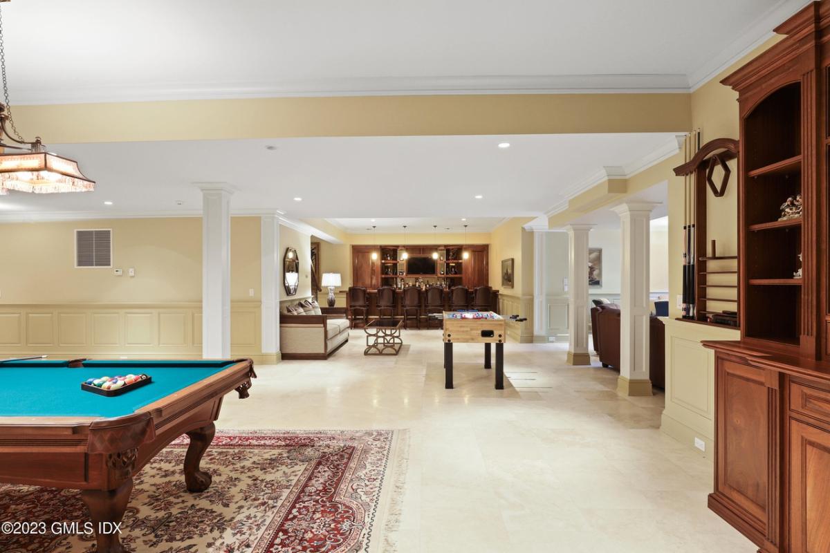 Recreational room with billiards table and a bar.