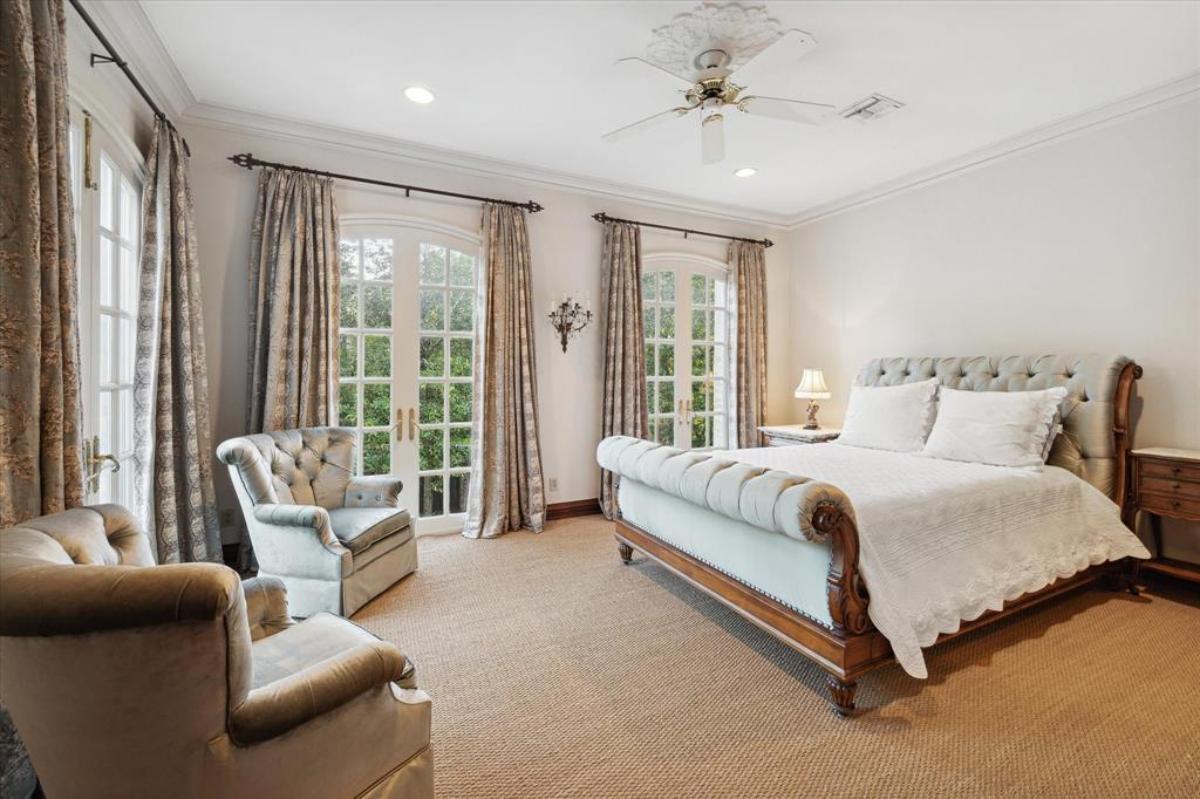 Bedroom with a large bed and carpet flooring.