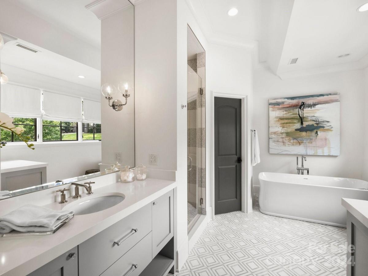 Bathroom with a sink and a soaking tub.