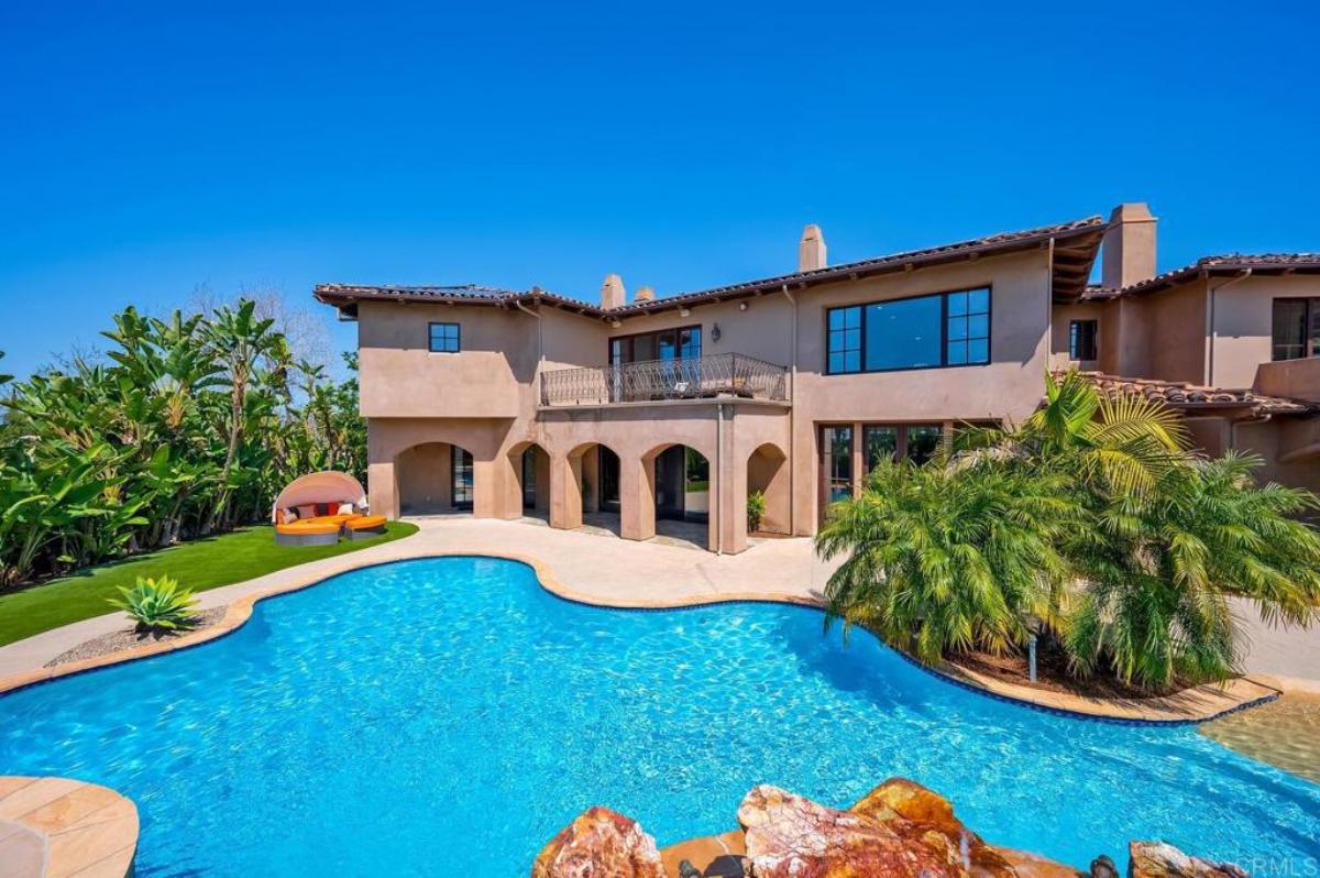 Rear view of the mansion with a pool.