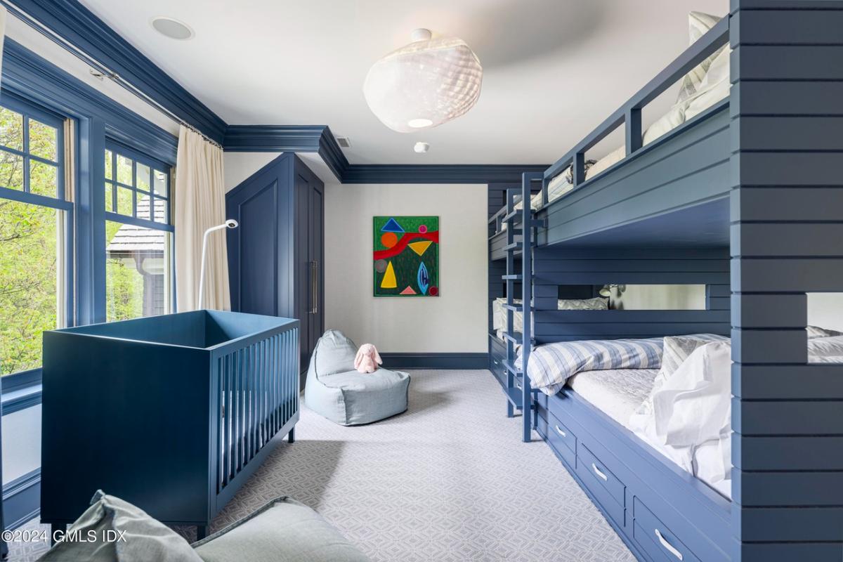 Children's bedroom with bunks and a crib.