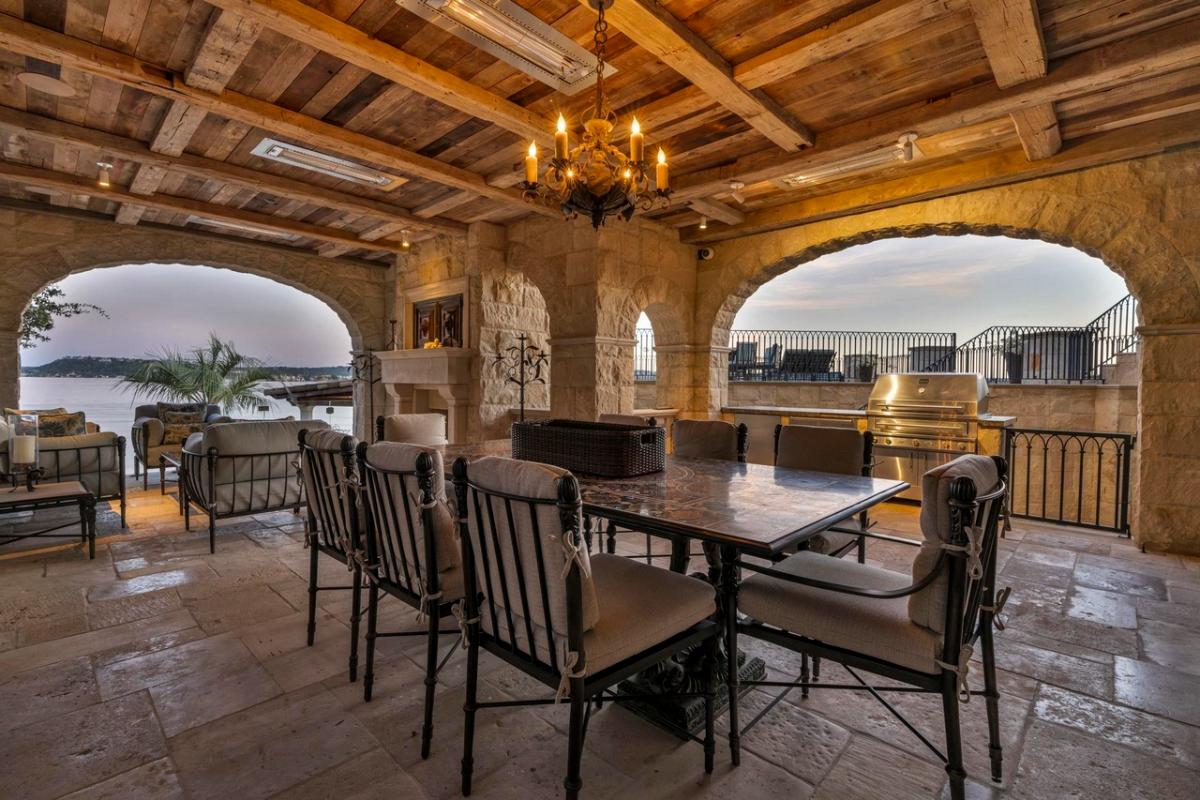 Covered patio with a dining area and a living space.