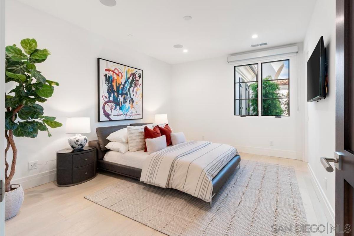 Bedroom with hardwood floors and glass windows.