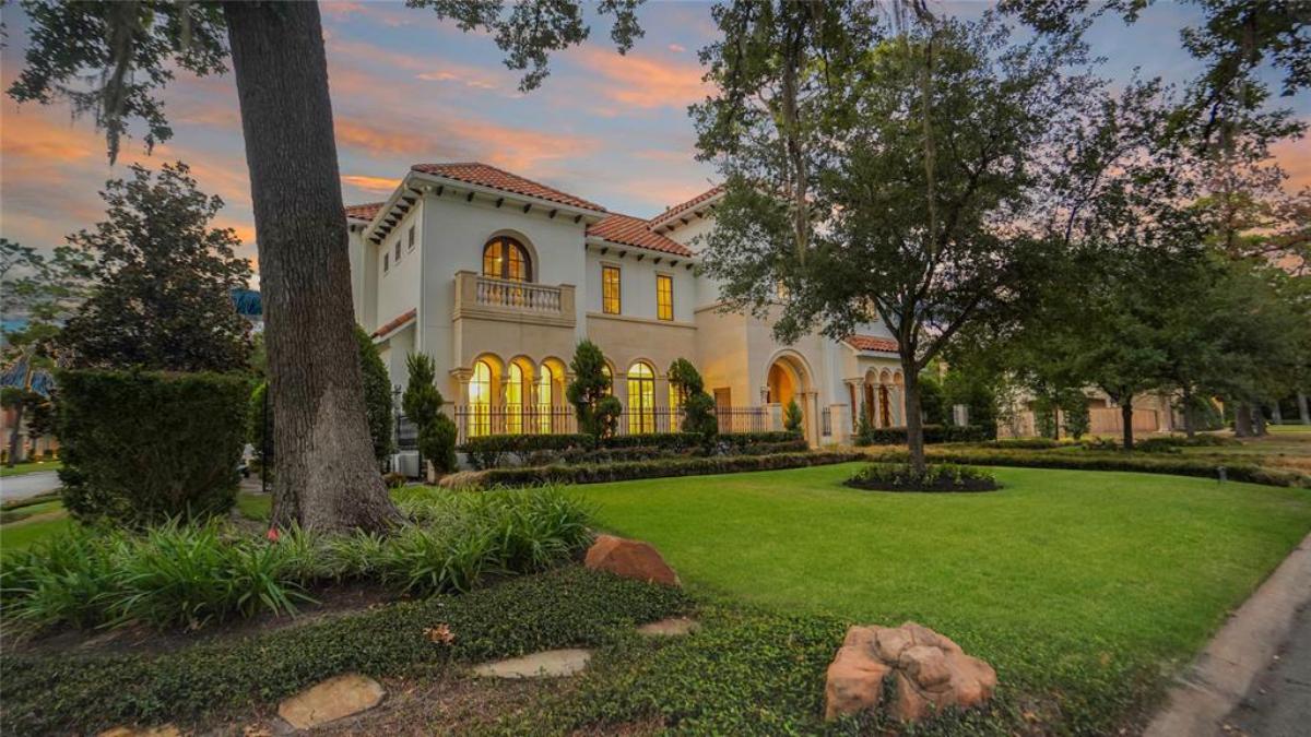 Front view of the mansion with a large lawn.