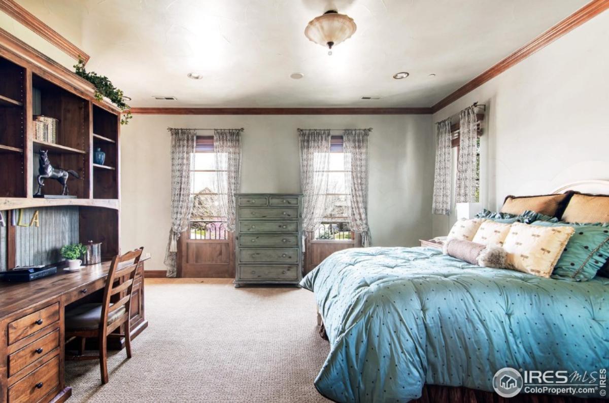 Bedroom with a large bed and carpet flooring.