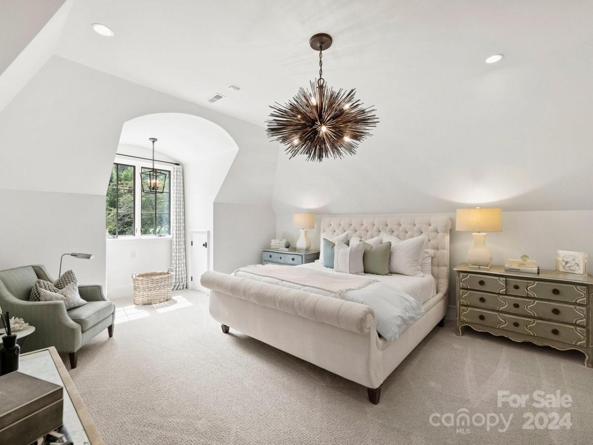 Bedroom with a large bed and carpet flooring.