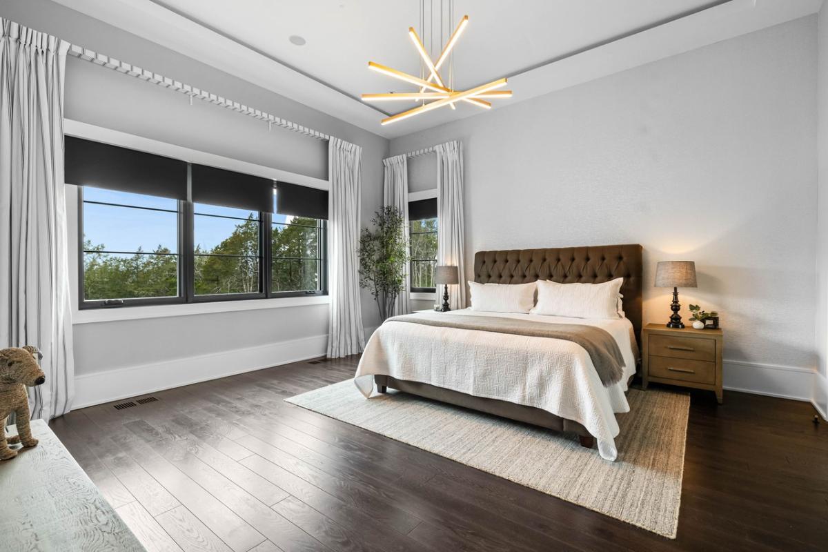 Bedroom with hardwood floors and glass windows.