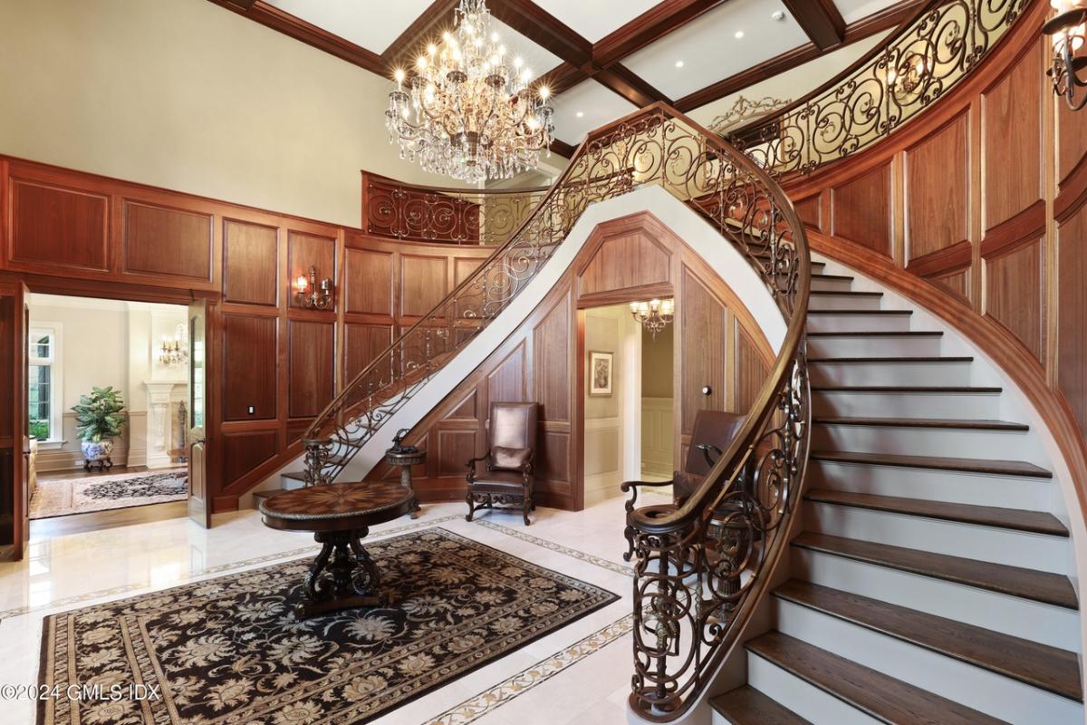 Foyer with a chandelier and stairs.