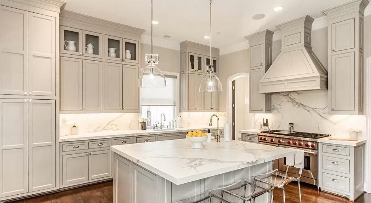 Kitchen with a large island, custom lighting and custom cabinetry.