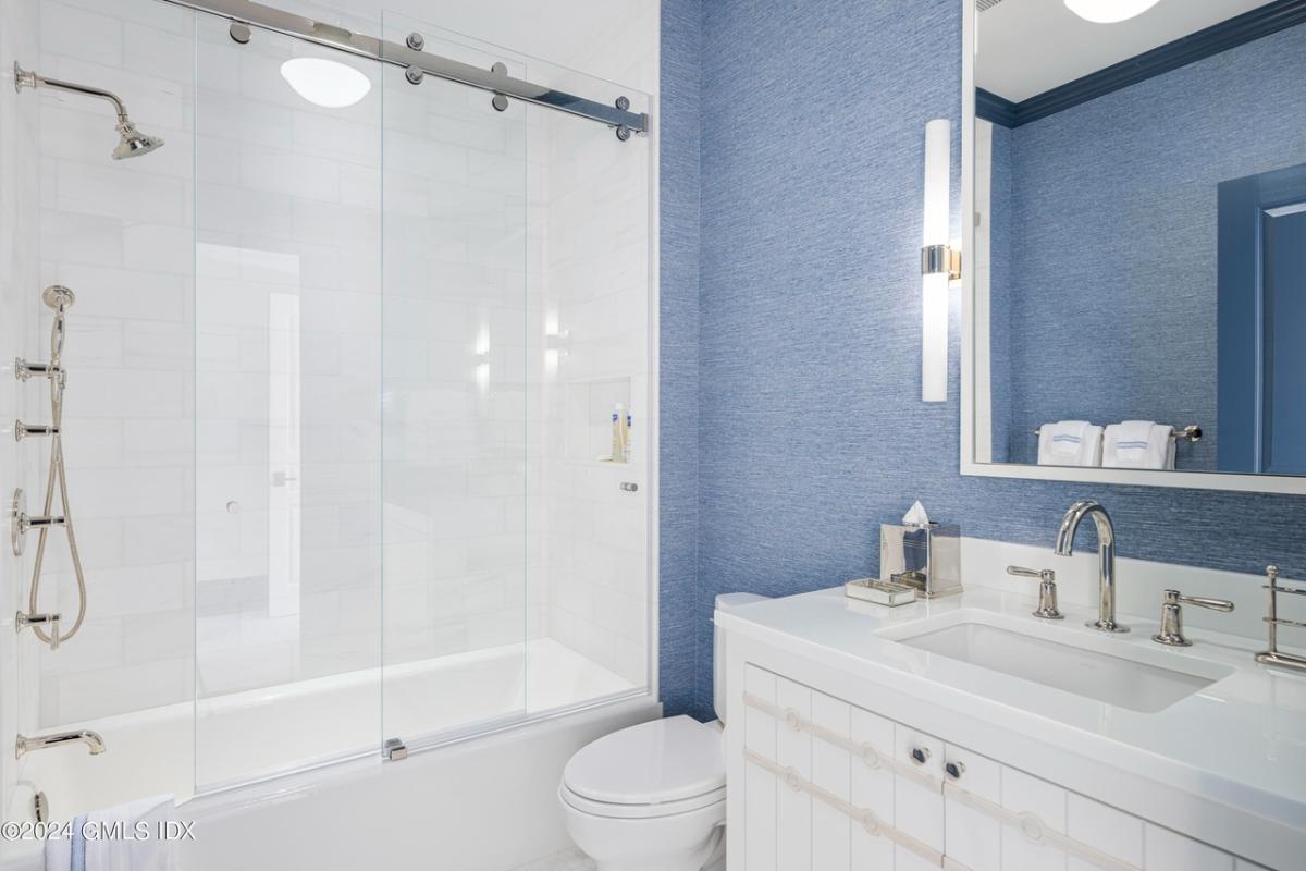 Bathroom with a sink, toilet and a walk-in shower.