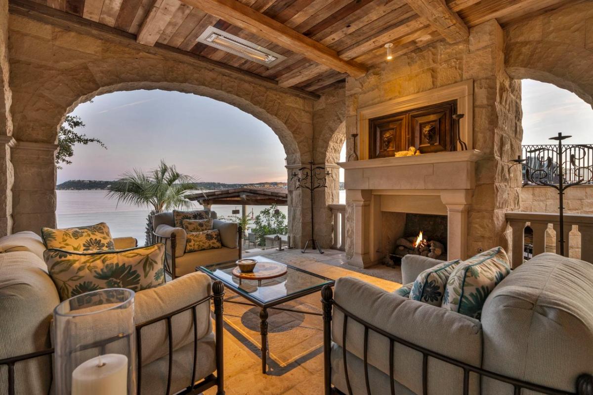 Covered patio with a living space and a fireplace.