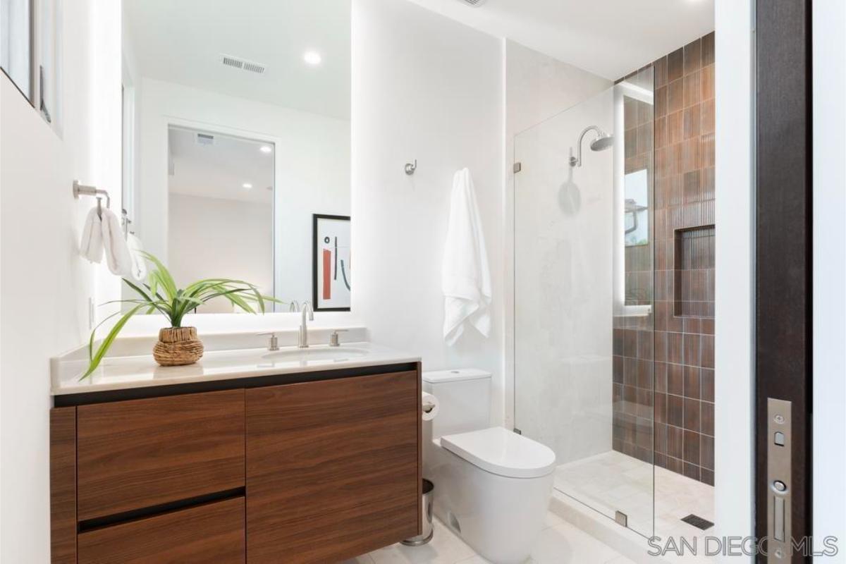 Bathroom with a sink, toilet and a walk-in shower.