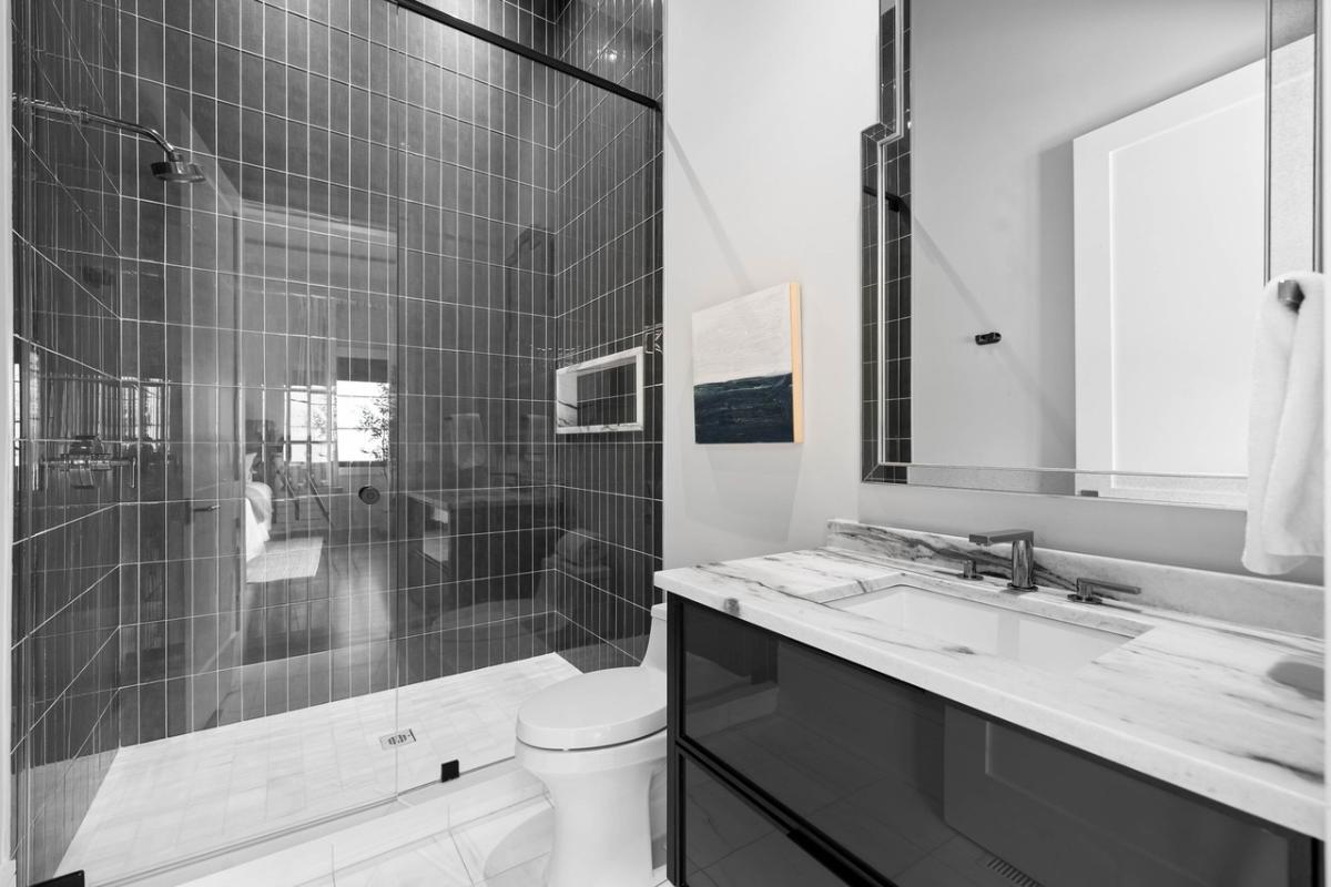 Bathroom with a sink, toilet and a walk-in shower.