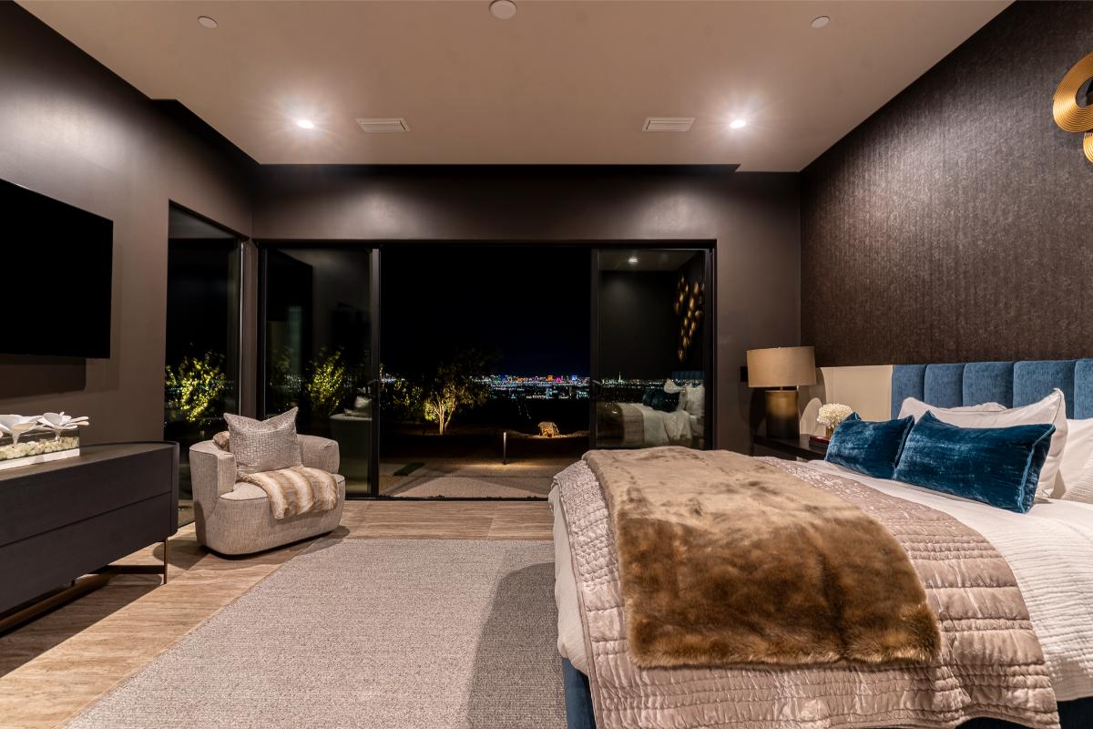 Bedroom with a large bed and a sliding glass door.
