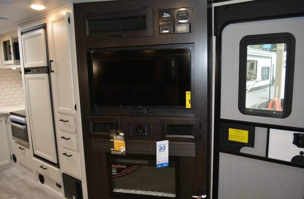 Entertainment center with a TV and a fireplace.