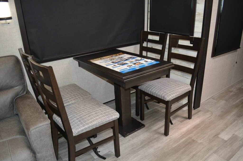 Dining area with a dark wood table paired with cushioned chairs.