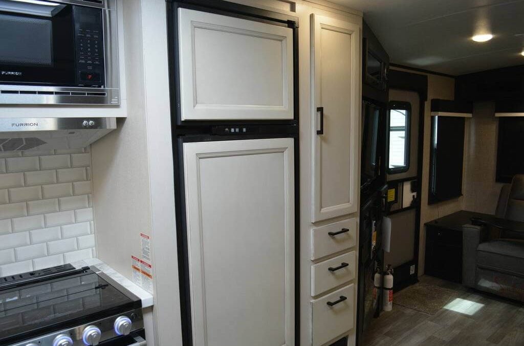 The kitchen includes built-in cabinets with white doors.