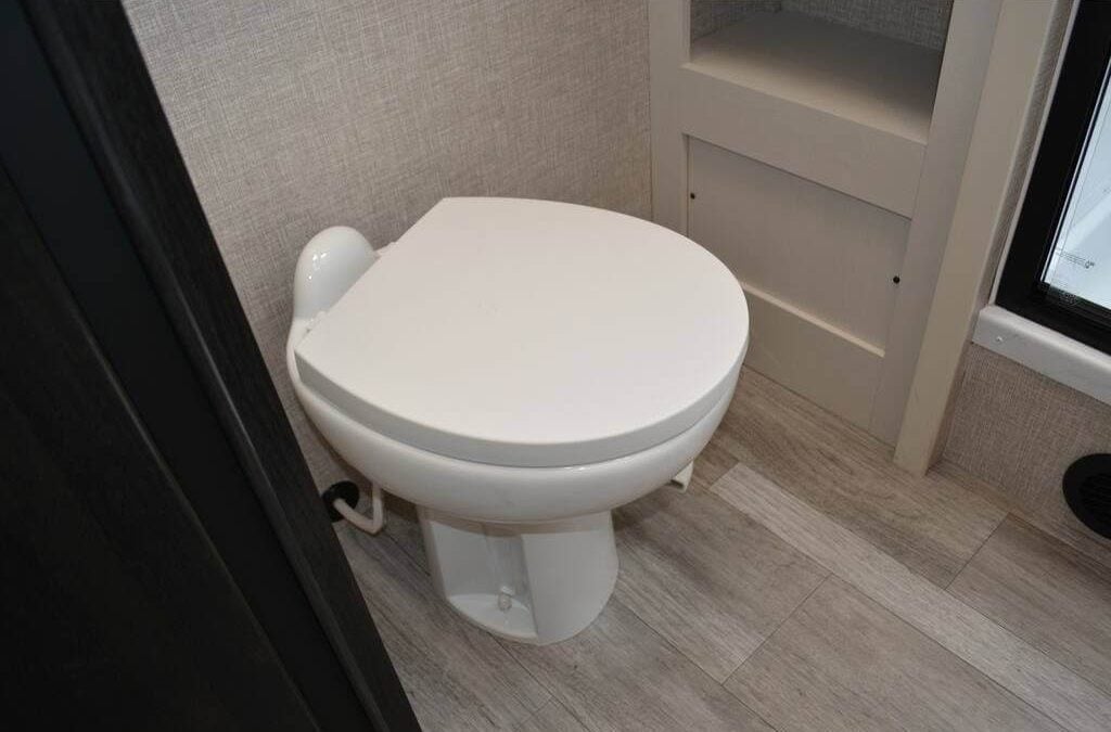 Bathroom with inset shelves and a vinyl floor.