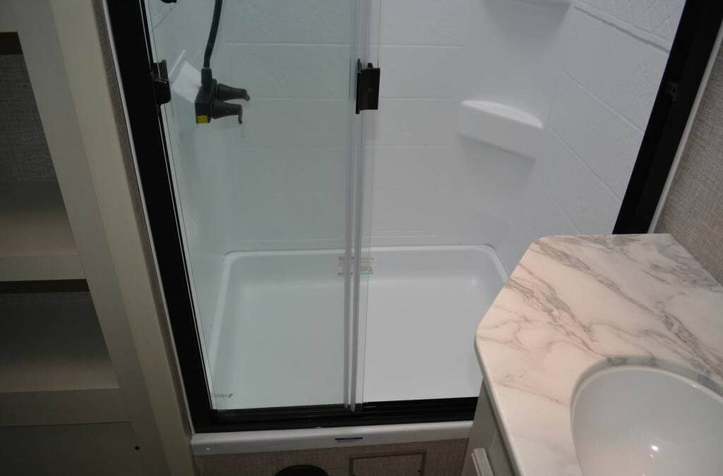Bathroom with a sink vanity and a walk-in shower.