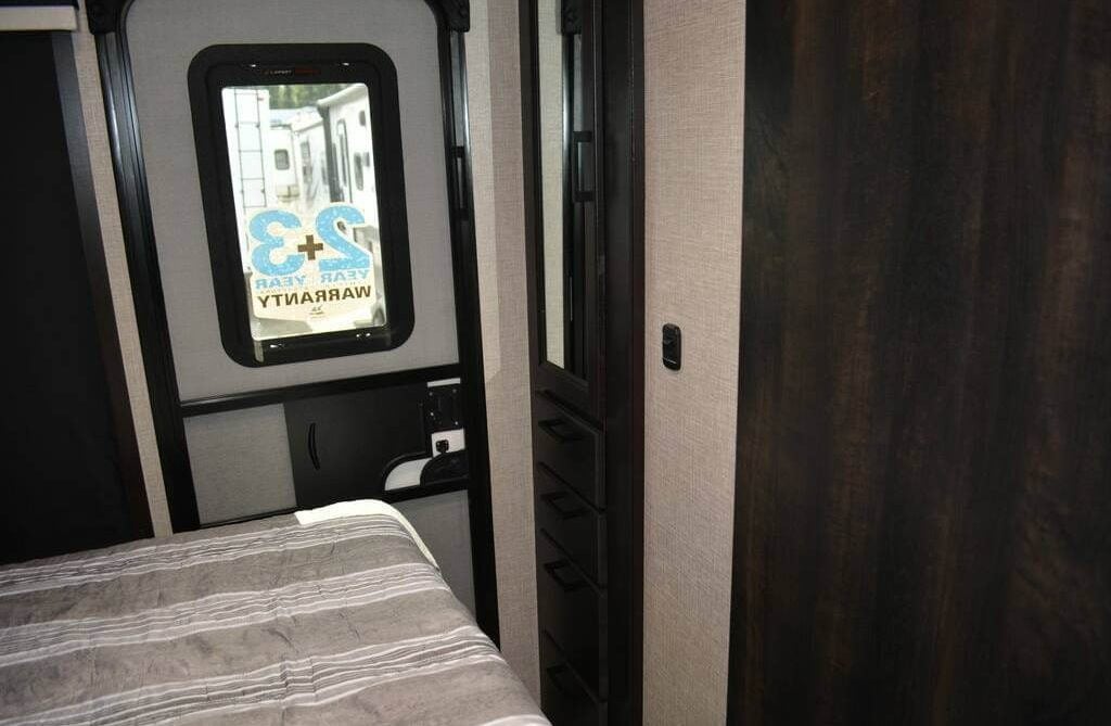 The bedroom includes a framed window and built-in closets.