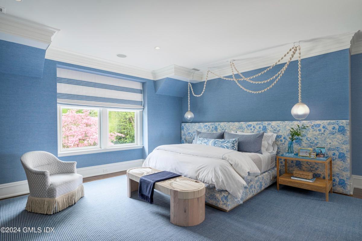 Bedroom with carpet flooring and glass windows.