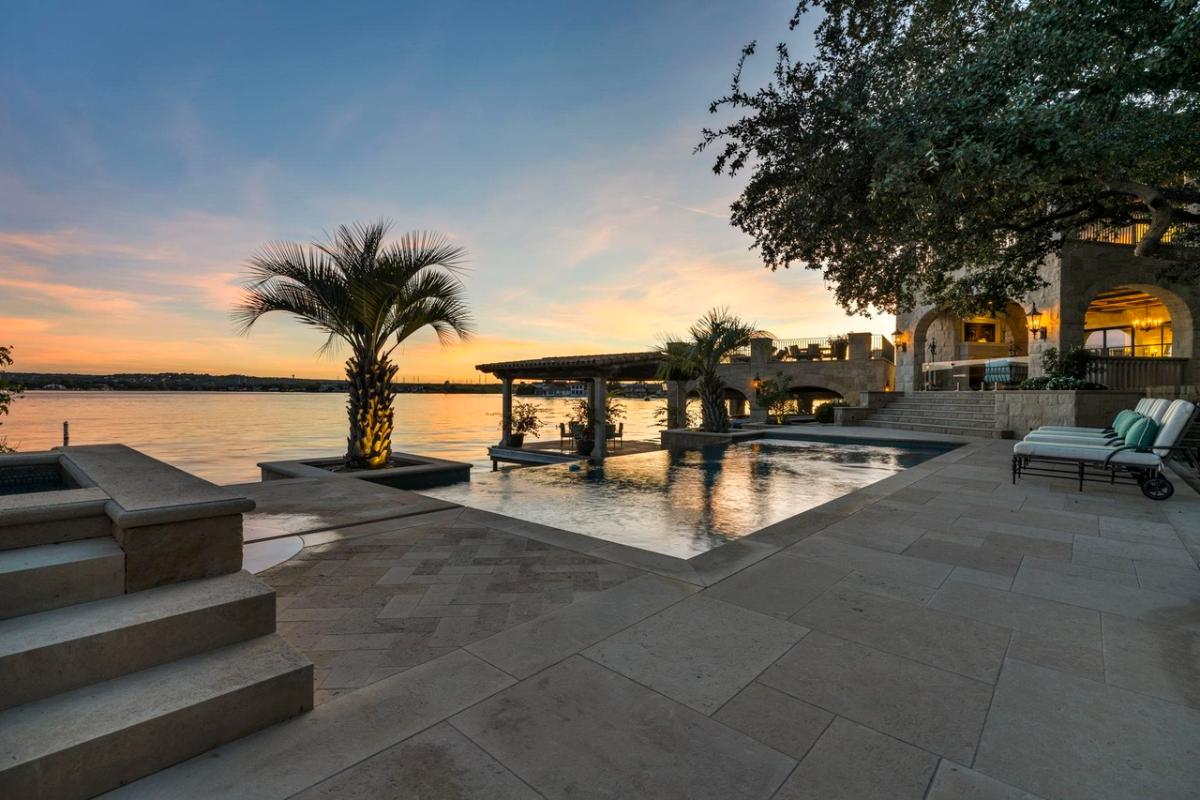 Pool with lounge chairs overlooking the lake.