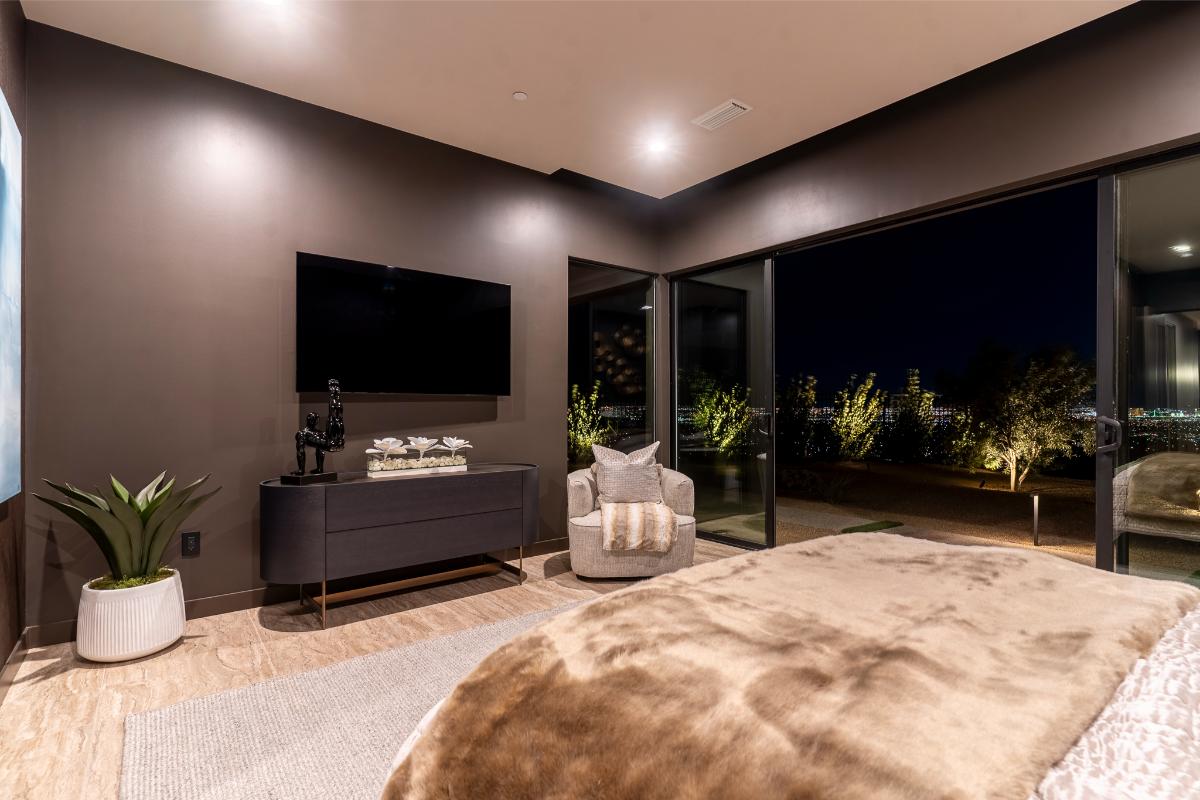 Bedroom with a large bed and a sliding glass door.