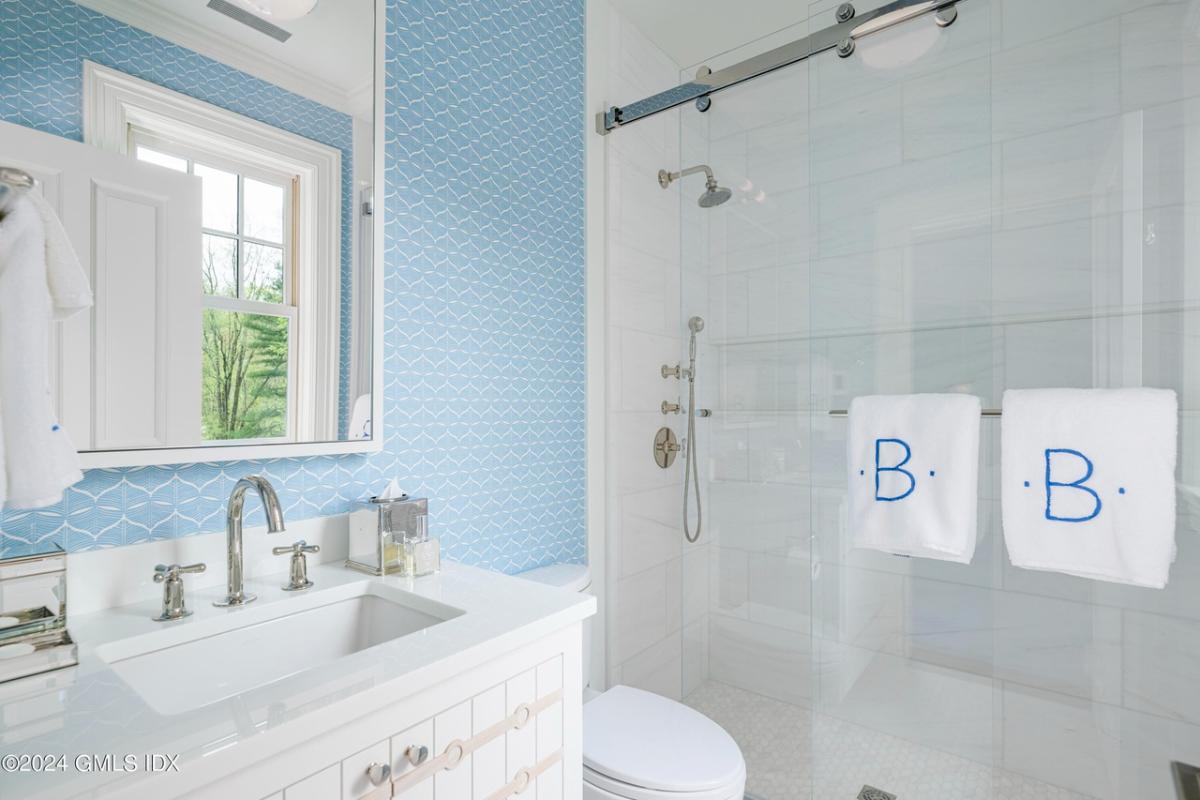 Bathroom with a sink, toilet and a walk-in shower.