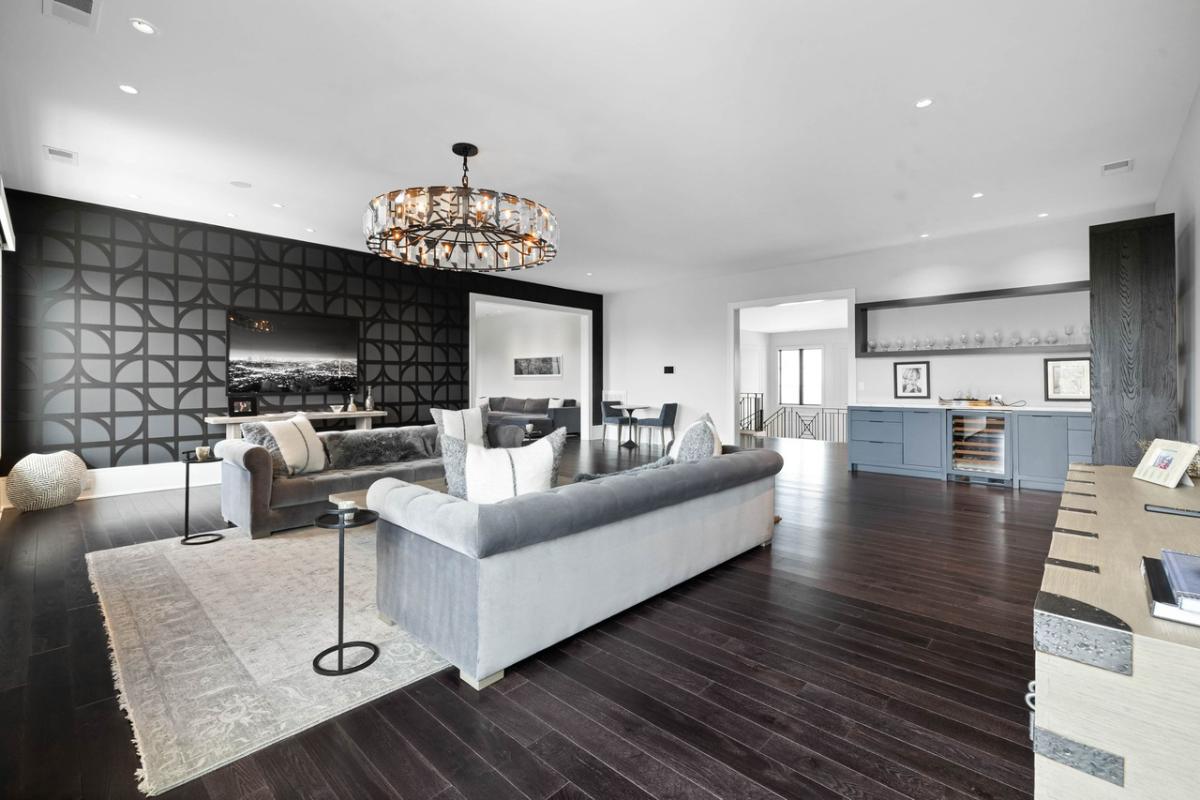 Living room with a chandelier and hardwood floors.