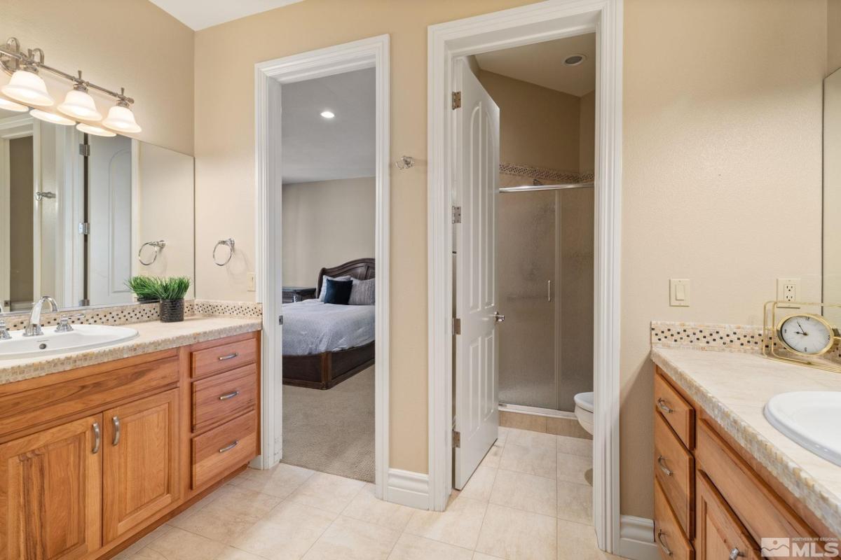 Bathroom with sinks and a walk-in shower.