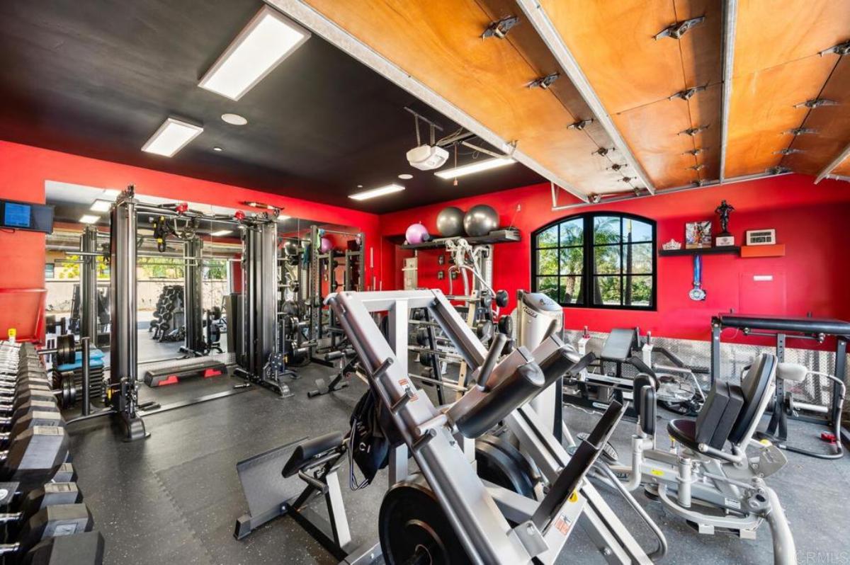 Home gym with lots of workout equipment.