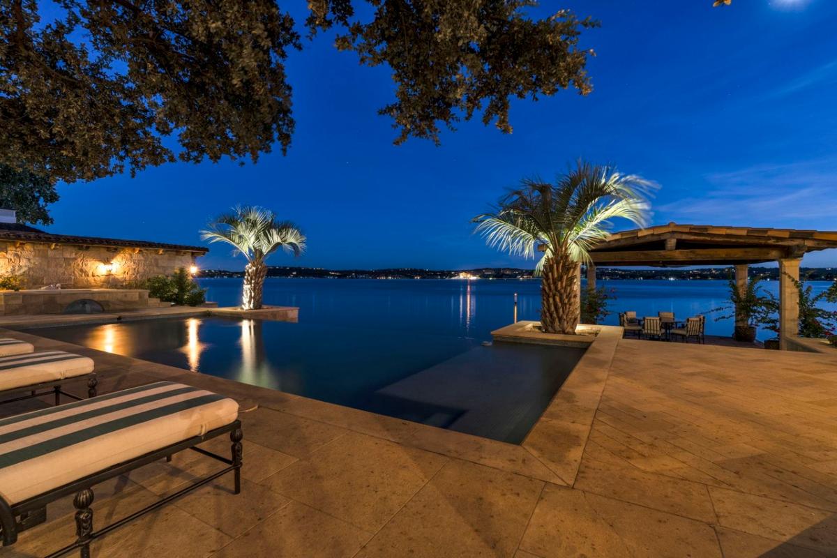 Pool with lounge chairs overlooking the lake.