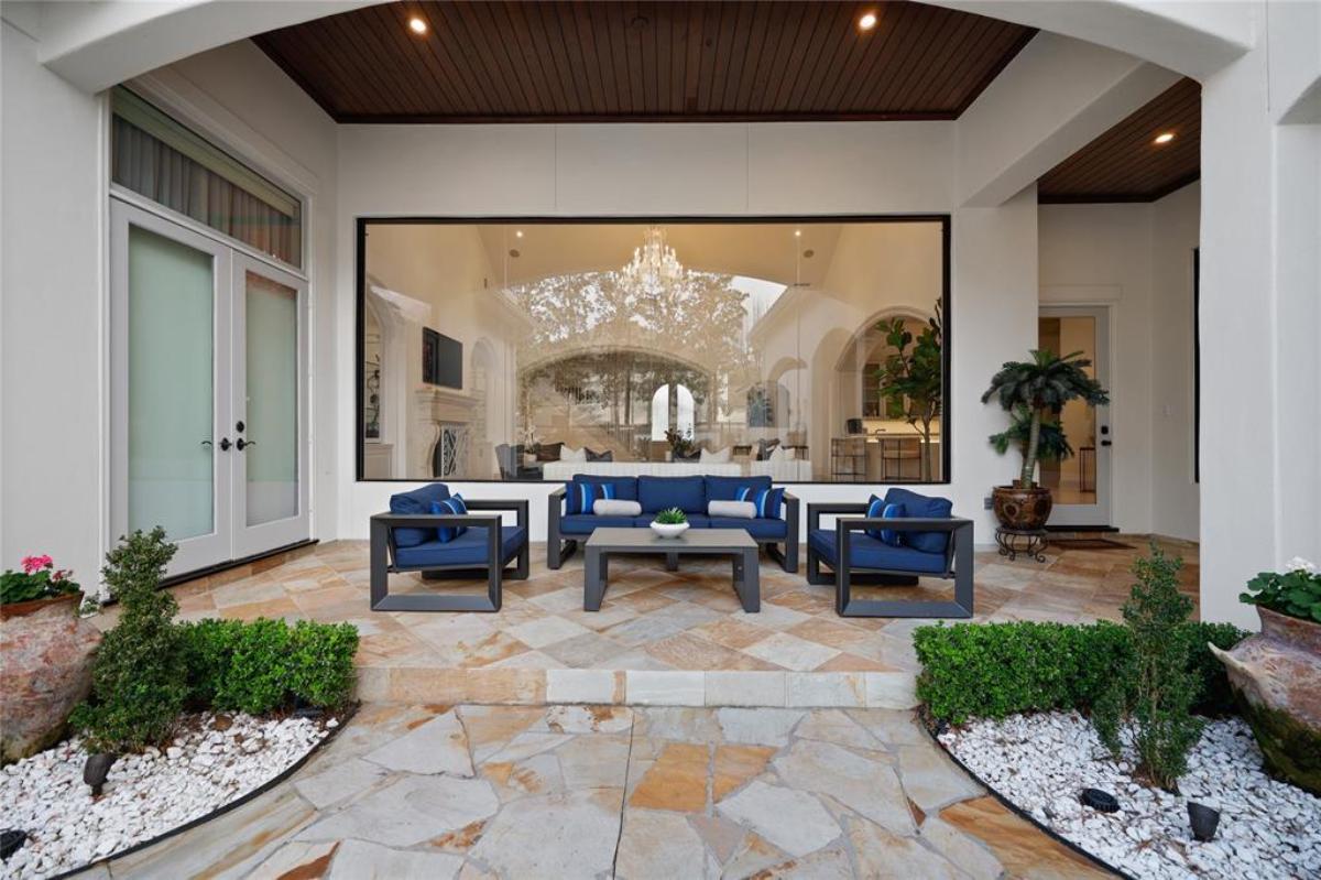 Covered patio with a table and chairs.