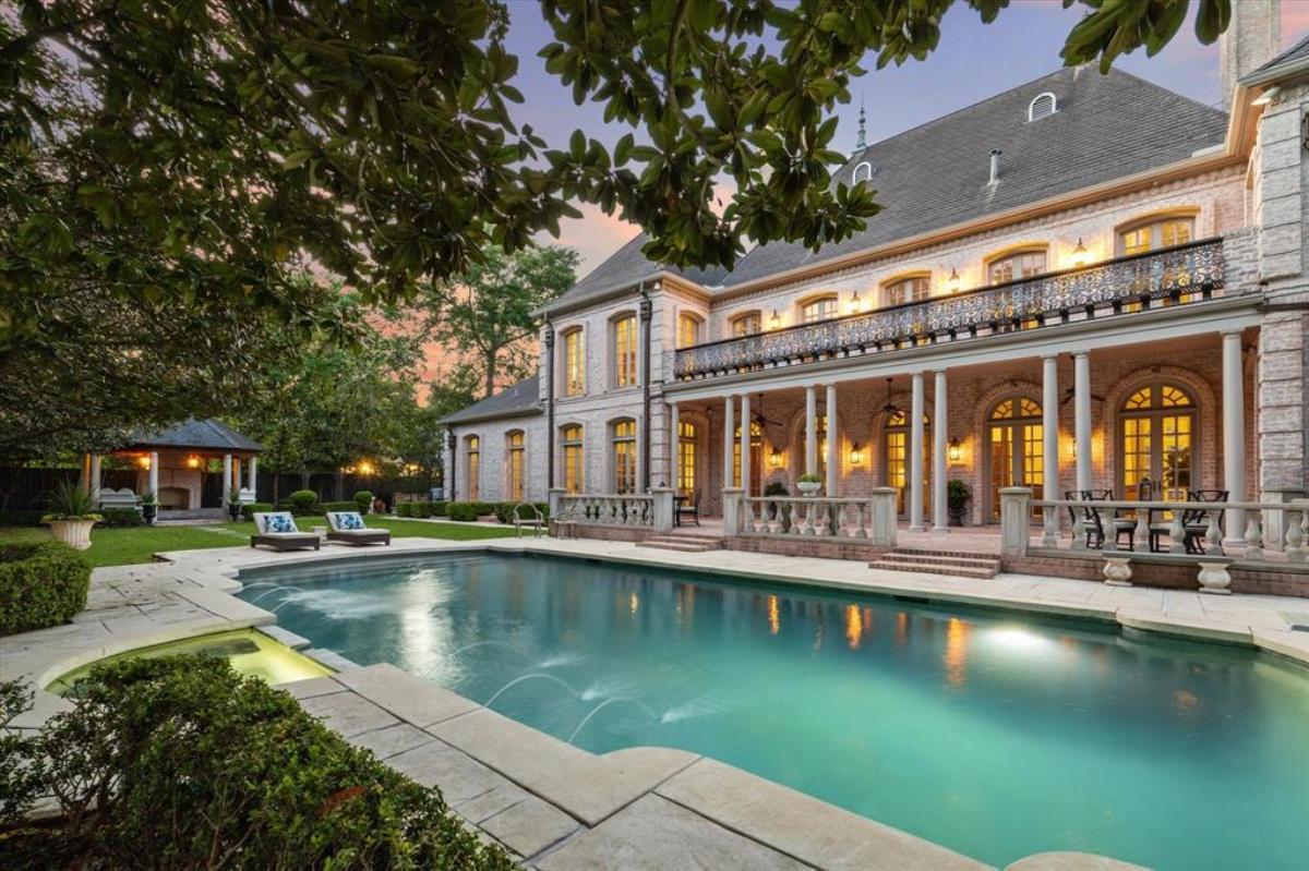 Rear view of the mansion with a pool.