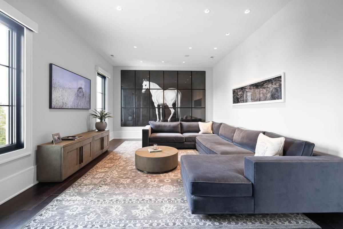 Living room with sofas and hardwood floors.