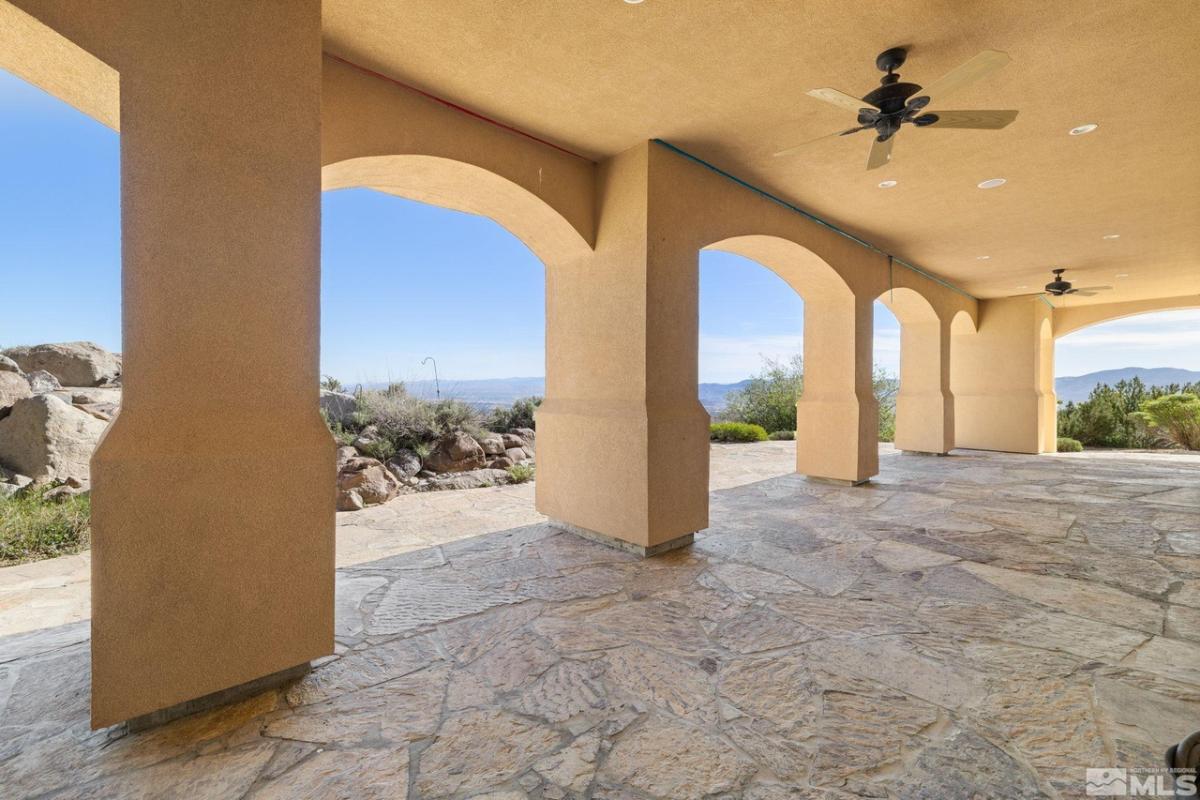Covered patio with a ceiling fan.