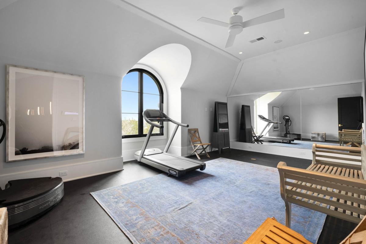 Home gym with a large mirror.
