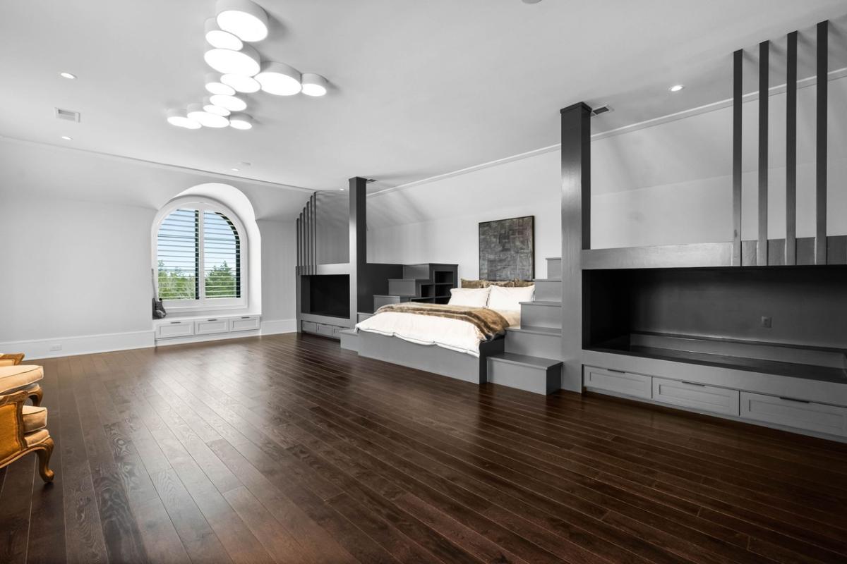 Bedroom with hardwood floors and glass windows.