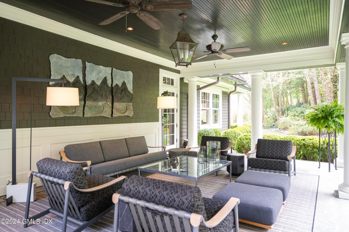 Covered patio with a table and chairs.